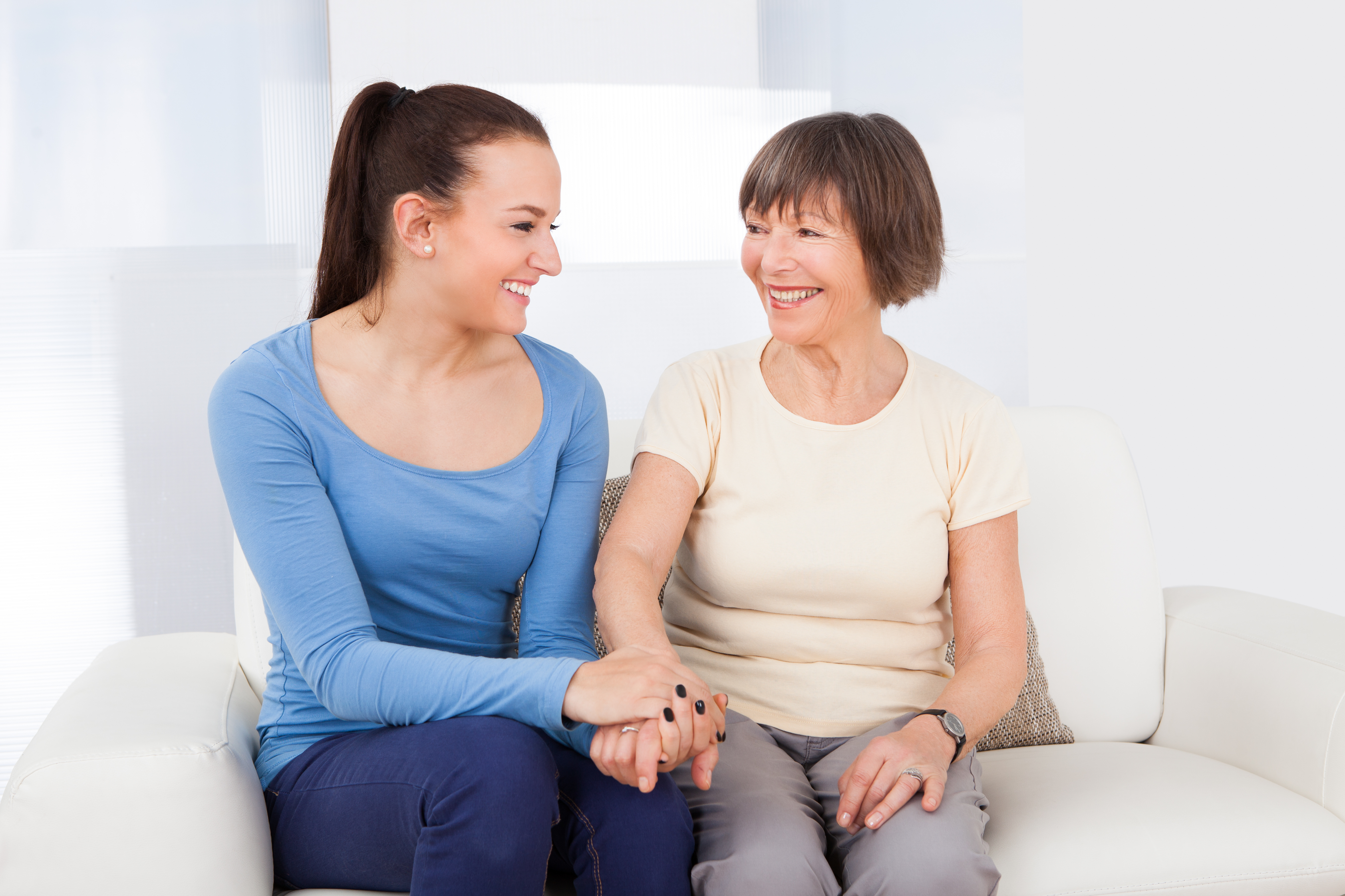Caregiver Consoling Senior Woman